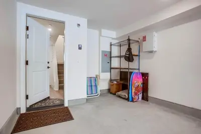 a hallway with a door open to a room with a skateboard at Bayside Cove 2 in San Diego
