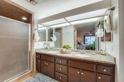 a bathroom with two sinks and a large mirror at Beach Haven 2 in San Diego