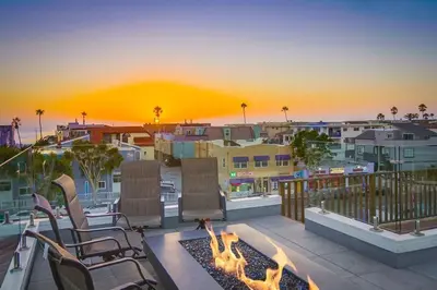 a patio with chairs and a fire pit on a balcony at Beach Haven 2 in San Diego