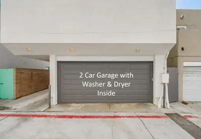 a garage door with a car garage with wastewater and driver inside at Beach Haven 2 in San Diego