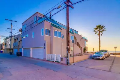 a house with a car parked in a parking lot at Beachside 2 in San Diego
