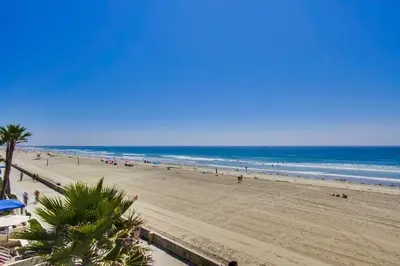 a view of a beach with palm trees and the ocean at Beachside 2 in San Diego