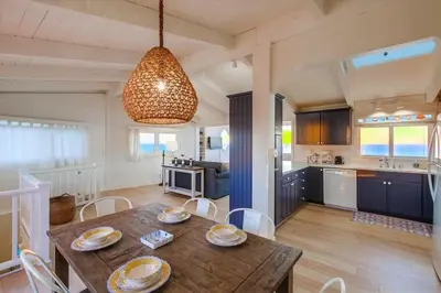 a dining room and kitchen with a table and chairs at Beacons in Encinitas