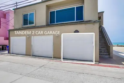 a building with two garage doors and a car garage at Beach Break 2 in San Diego