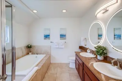 a bathroom with two sinks and a tub and a toilet at Beach Break 2 in San Diego