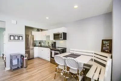 a kitchen with a table and some chairs in it at Beachy Keen 1 in San Diego