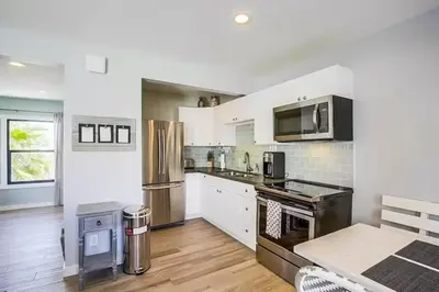 a kitchen with white walls and stainless steel appliances at Beachy Keen 1 in San Diego