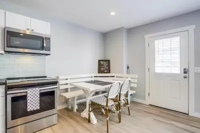 a kitchen with a table and chairs in a kitchen at Beachy Keen 1 in San Diego
