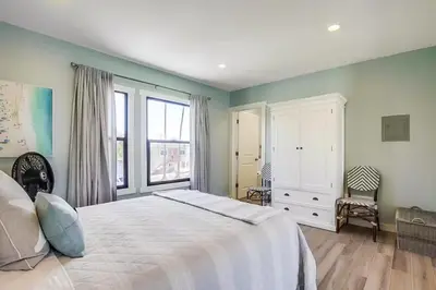 a bedroom with a large white bed and a window at Beachy Keen 1 in San Diego