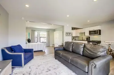 a living room with a couch and a kitchen at Beachy Keen 1 in San Diego