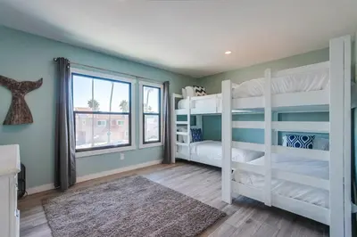 a bedroom with two bunk beds and a window at Beachy Keen 2 in San Diego
