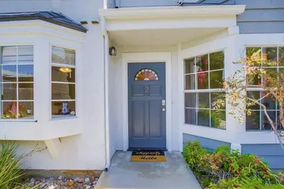 a house with a blue door and windows at Local Gem 2 in San Diego