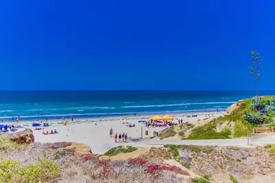 a group of people on a beach with the ocean at Local Gem 2 in San Diego