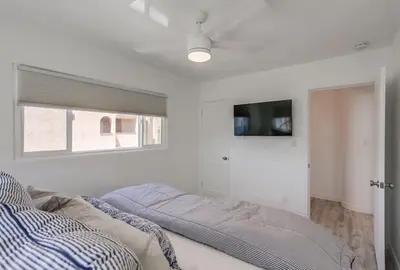 a bedroom with a bed and a flat screen tv at Boardwalk 2 in San Diego