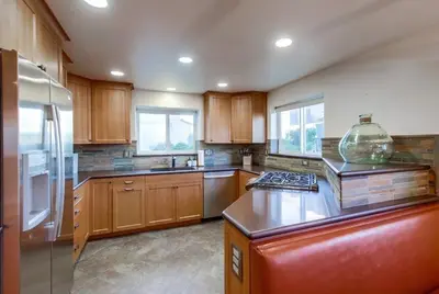 a kitchen with wooden cabinets and a large bowl on the counter at Ocean Style in San Diego
