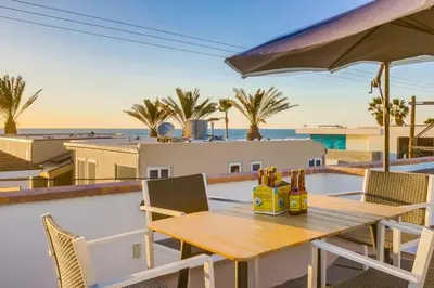 a table and chairs on a balcony with a view of the ocean at Ocean Style in San Diego