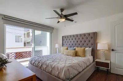 a bedroom with a bed and a ceiling fan at Ocean Style in San Diego