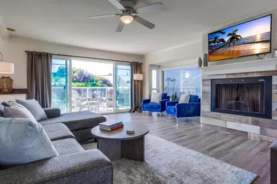 a living room with a couch and a fireplace at Pacific Shores in San Diego