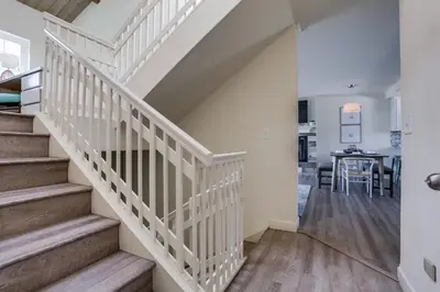 a white staircase in a house with a dining room at Pacific Shores in San Diego