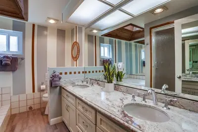 a bathroom with two sinks and a large mirror at Pacific Shores in San Diego