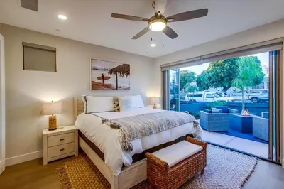 a bedroom with a bed and a large window at CA Dreaming in San Diego