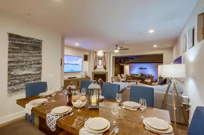 a dining room with a table and a living room at CA Dreaming in San Diego