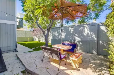 a patio with a table and an umbrella at Endless Summer 2 in San Diego