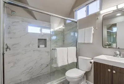 a bathroom with a shower and a toilet and a sink at Palms Paradise 2 in San Diego