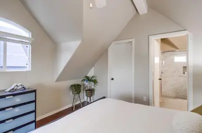 a bedroom with a bed and a dresser and a window at Palms Paradise 2 in San Diego