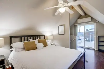 a bedroom with a white bed with a ceiling fan at Palms Paradise 2 in San Diego