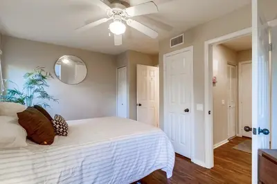 a bedroom with a white bed and a ceiling fan at Palms Paradise 2 in San Diego