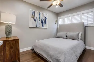 a bedroom with a bed and a ceiling fan at Bayside Bikini 1 in San Diego