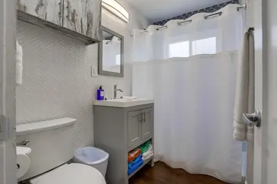 a white bathroom with a sink and a toilet at Bayside Bikini 1 in San Diego