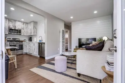 a living room with a couch and a kitchen at Bayside Bikini 1 in San Diego