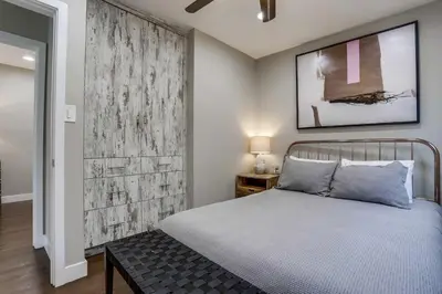 a bedroom with a bed and a wooden wall at Bayside Bikini 1 in San Diego