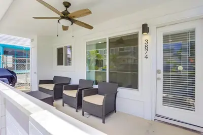 a porch with chairs and a ceiling fan at Bayside Bikini 1 in San Diego