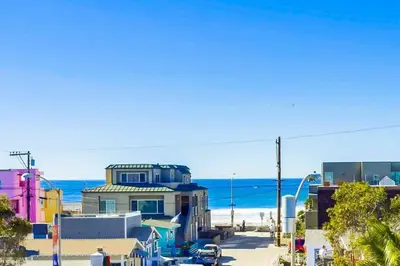 a building on the beach with the ocean in the background at Bay View in San Diego
