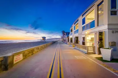 a building next to the beach at sunset at Surf Style 3 in San Diego
