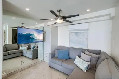 a living room with a couch and a ceiling fan at Surf Style 3 in San Diego