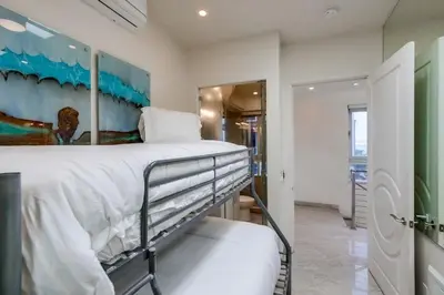 a bedroom with a bed with a painting on the wall at Surf Style 3 in San Diego