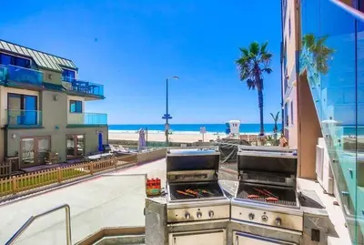 a view of a patio with a grill and a beach at Residence Club 3 in San Diego