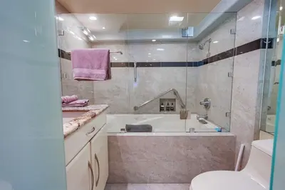 a bathroom with a tub and a toilet and a sink at Residence Club 3 in San Diego
