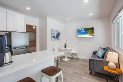 a kitchen and a living room with a counter top at Strandway Suite 3 in San Diego