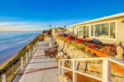 a house on the beach next to the ocean at Sunset Beach in Encinitas