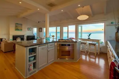 a kitchen with an island with a stove top oven at Sunset Beach in Encinitas