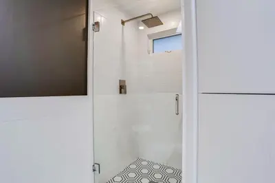 a bathroom with a shower with a glass door at Surf House in Encinitas