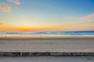 a sunset on a beach with the ocean at Beachside 4 in San Diego