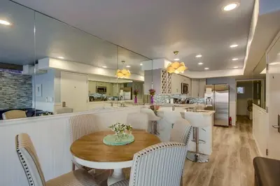 a dining room and kitchen with a table and chairs at Beachside 4 in San Diego