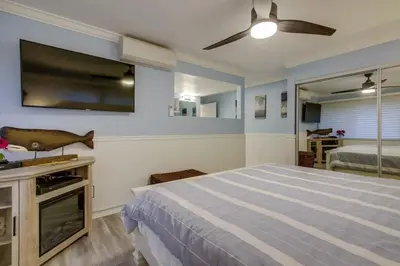 a bedroom with a bed and a flat screen tv at Beachside 4 in San Diego
