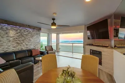a living room with a couch and a table with chairs at Beachside 4 in San Diego